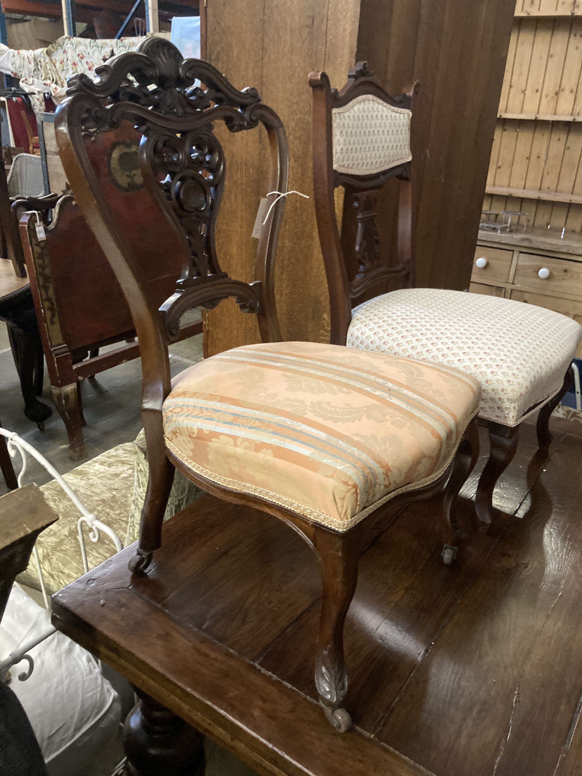 A pair of Victorian walnut dining chairs, on cabriole legs